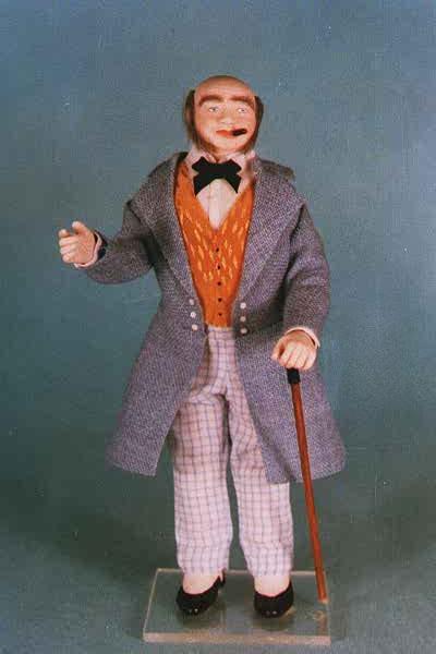 This Miniature Doll is dressed in a blue frock coat